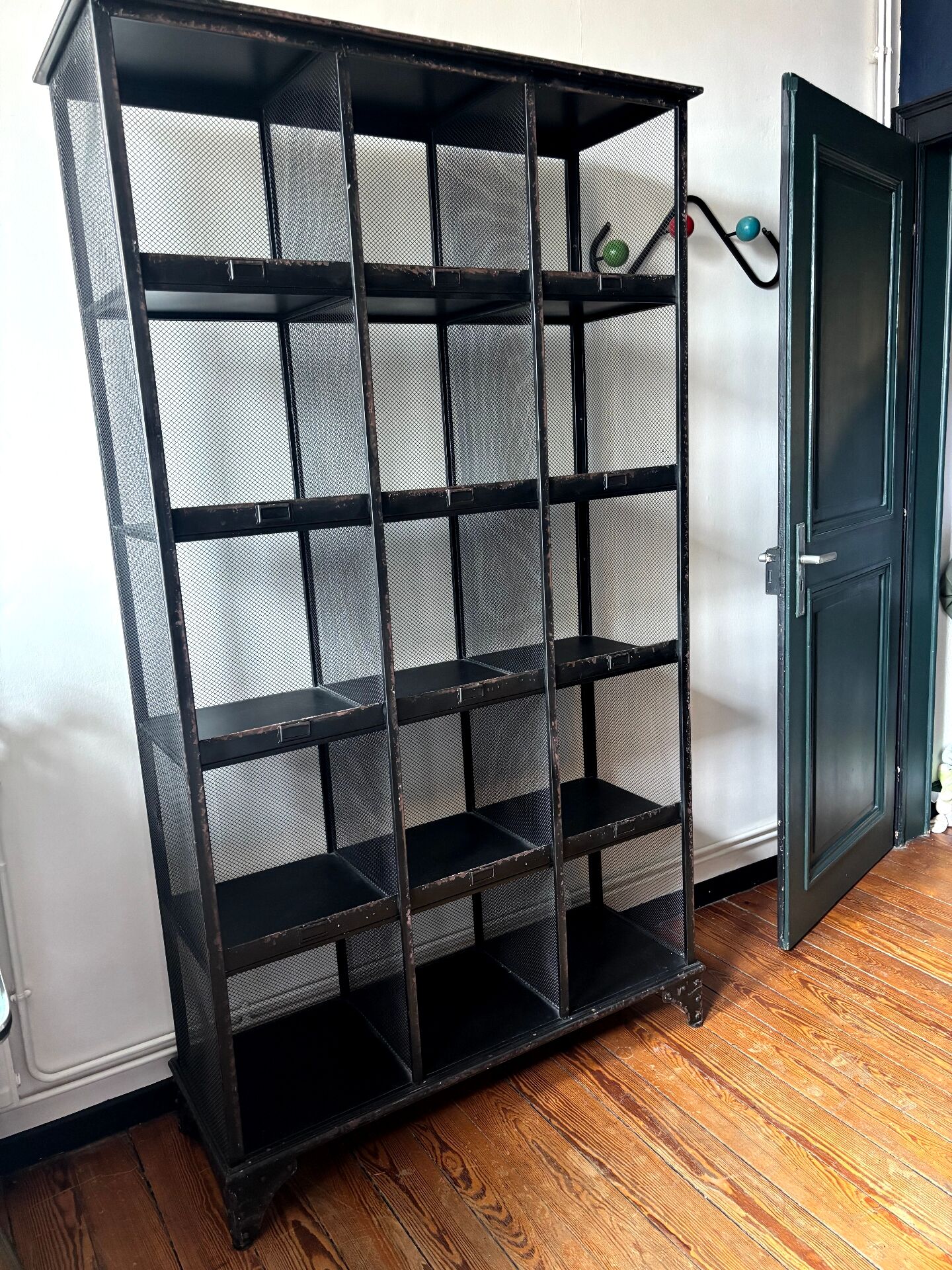 Black metal shelf with compartments.