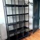 Black metal shelf with compartments.