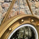 Witch mirror porthole style in gilded wood, diameter 44 cm.