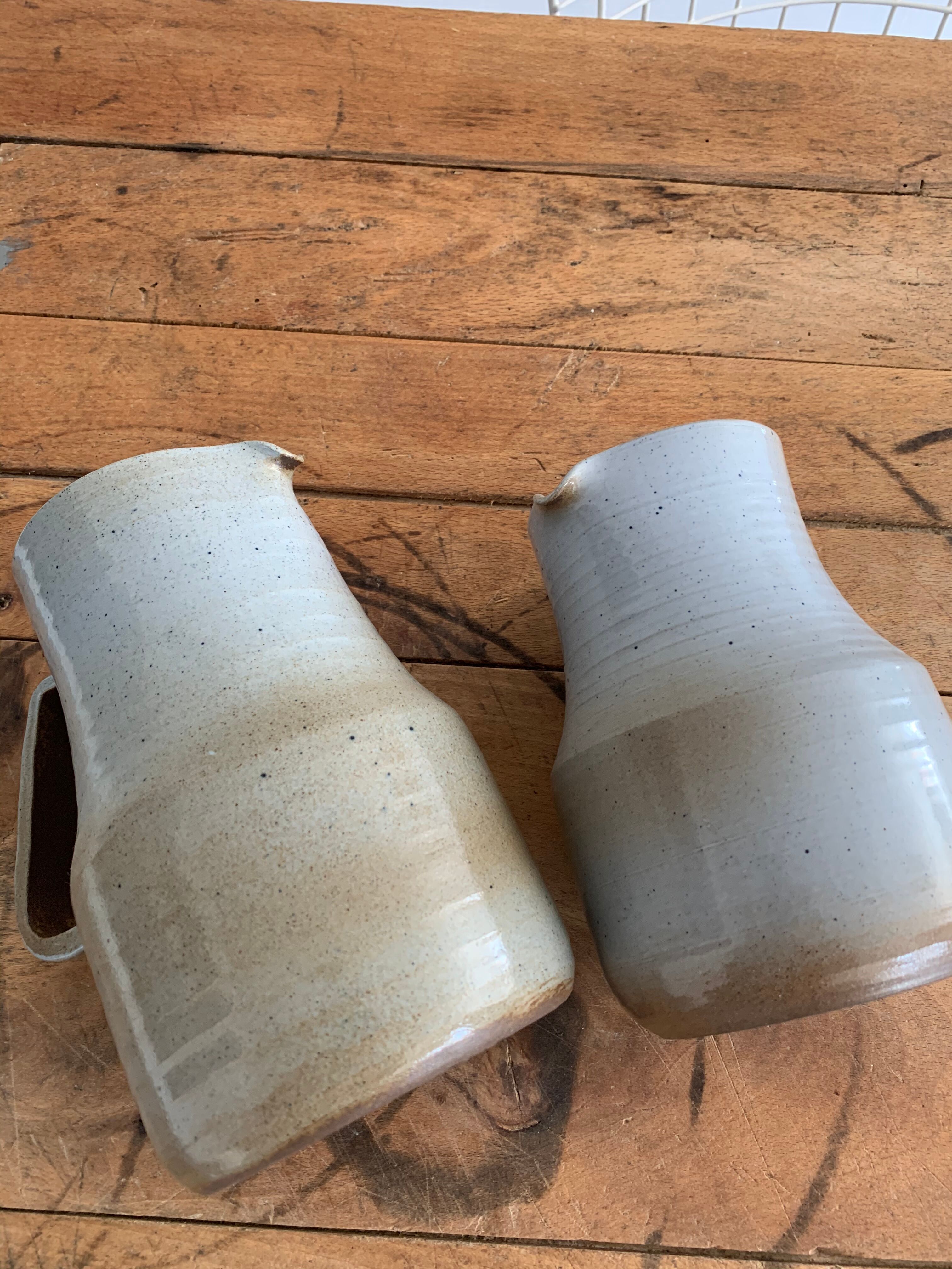 Pair vintage enamelled ceramic pitchers