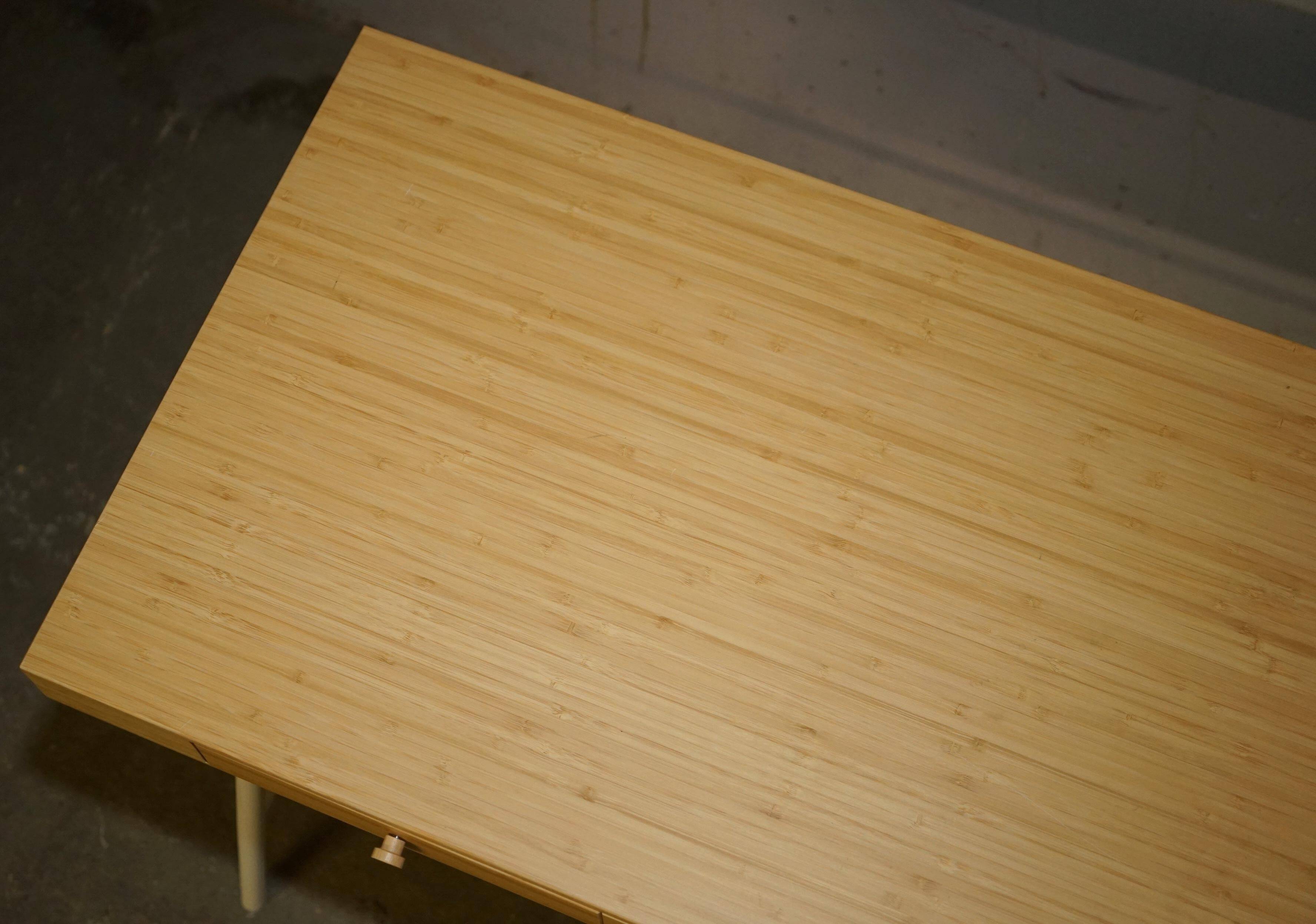 Small bamboo desk with three drawers.