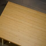 Small bamboo desk with three drawers.