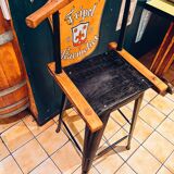 Antique bar stool with wooden seat