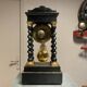 Pendule portique époque Napoléon III en marquèterie, palissandre et bois noirçi a décors de bronzes dorés