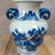 Blue and white Chinese vase with sculpted handles and landscape decoration.