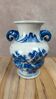 Blue and white Chinese vase with sculpted handles and landscape decoration.