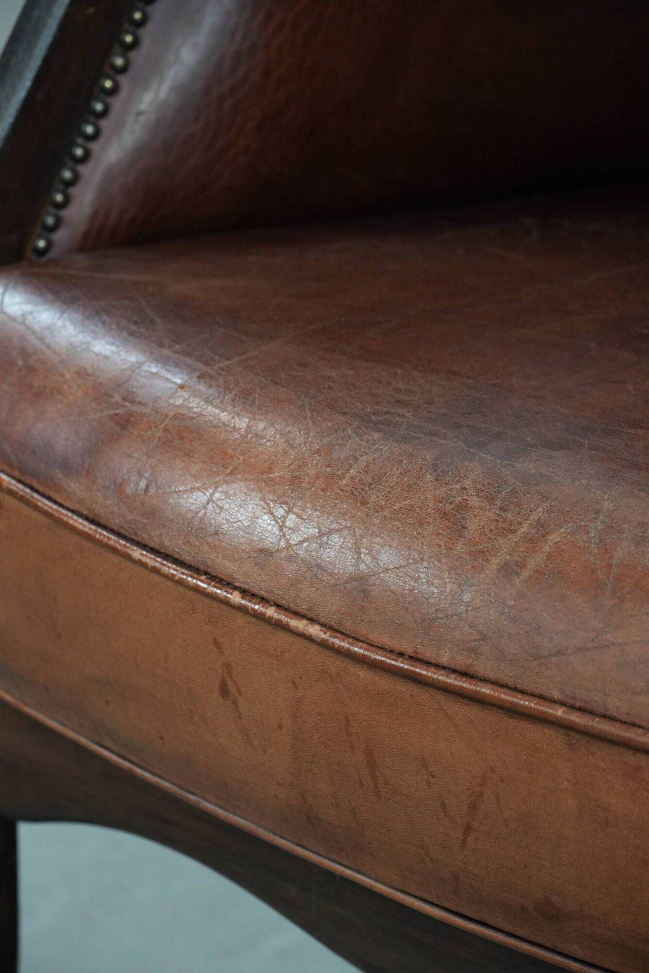 Classic vintage wingback chair in sheepskin and wood