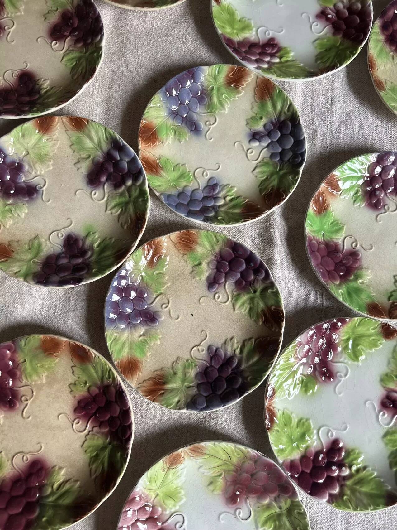 Set of eight flat dessert plates in barbotine earthenware with grape decoration – circa 1900.