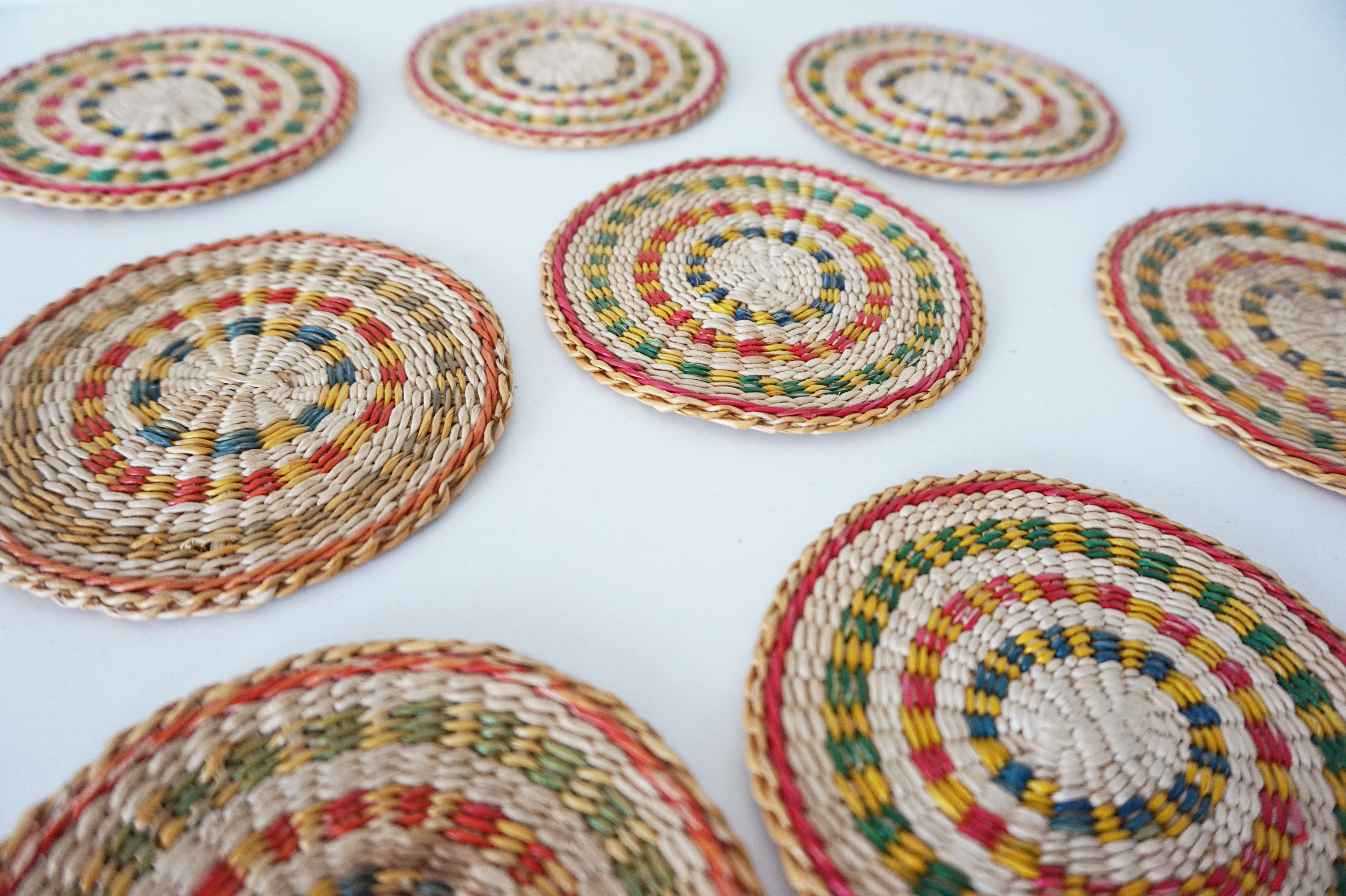 Set of coasters and bottles in colored wicker