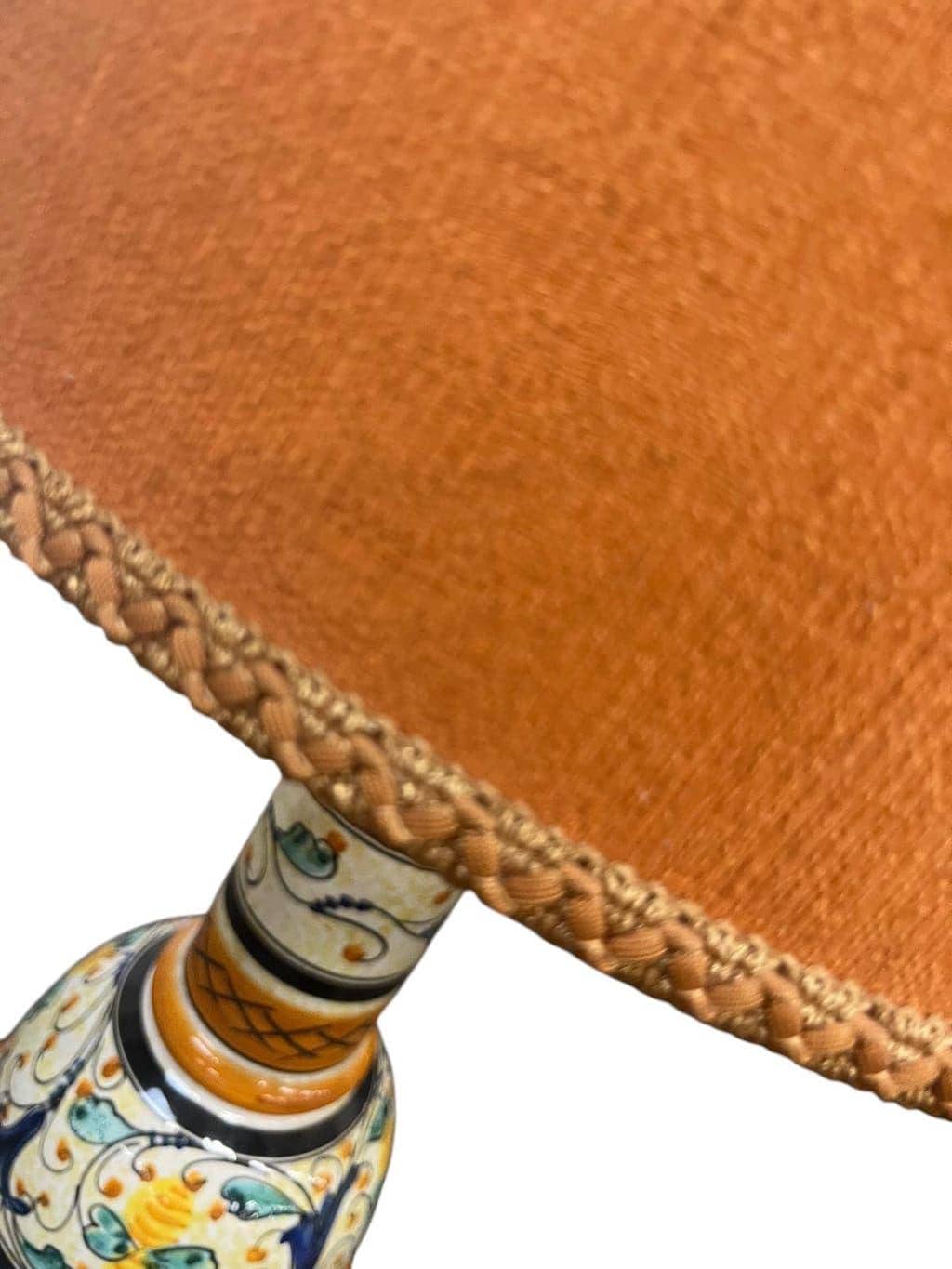 Vintage orange Portuguese table lamp with a ceramic base.