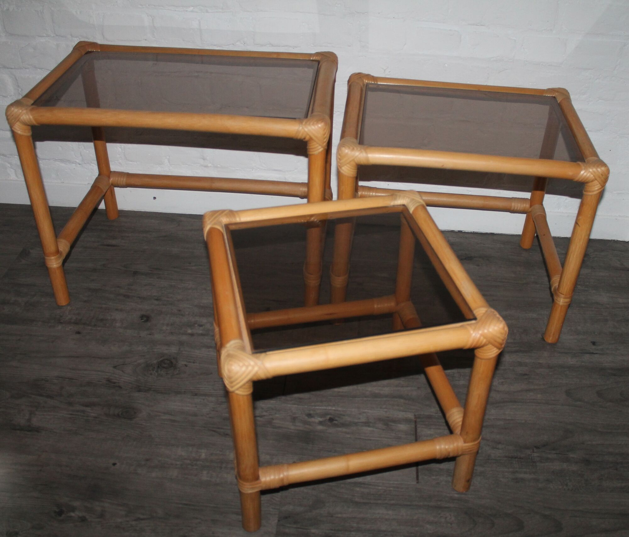 Rattan nesting tables in rattan and smoked glass from the 70s