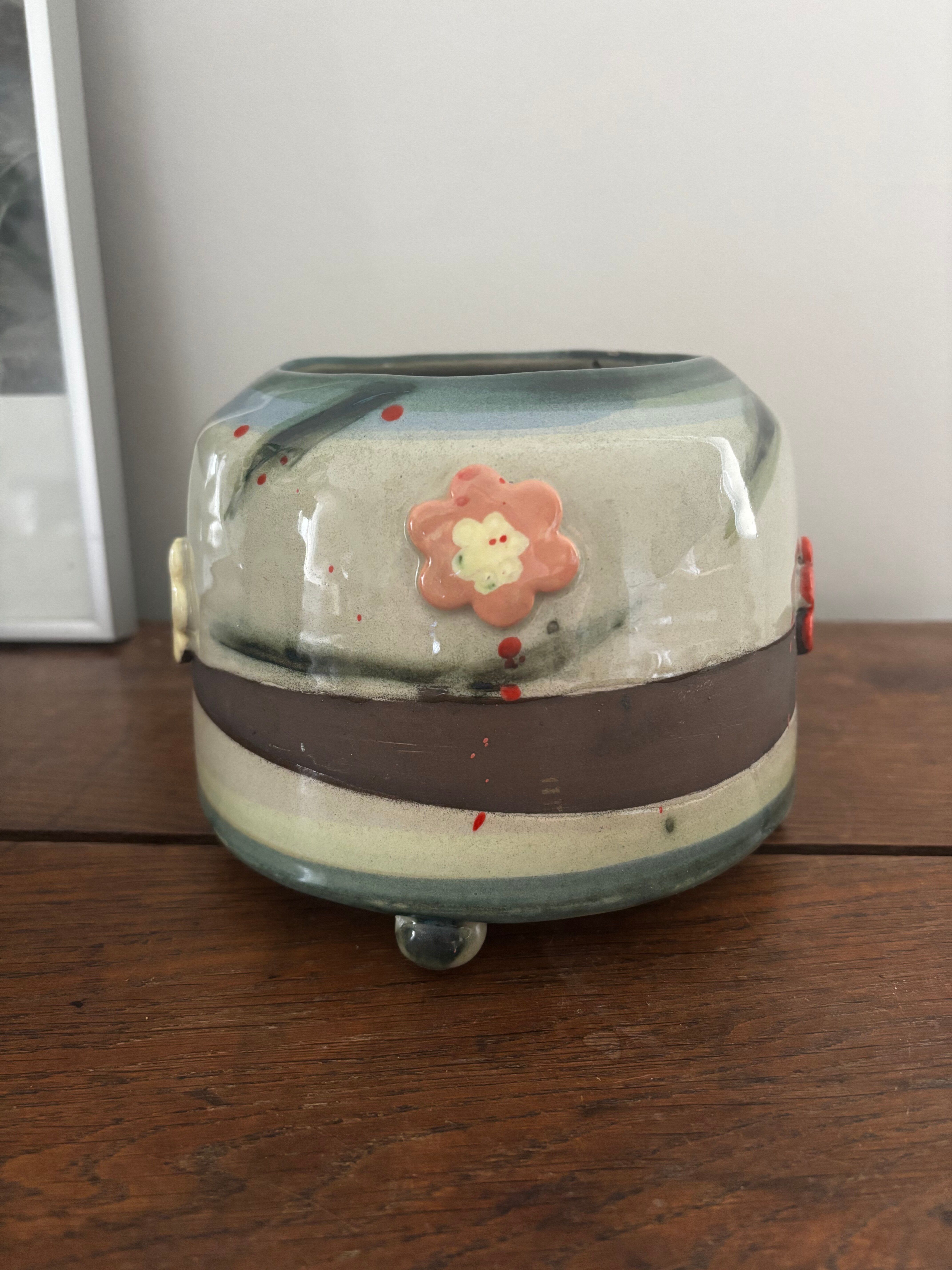 Superb handcrafted pottery pot with relief flowers signed on the back.