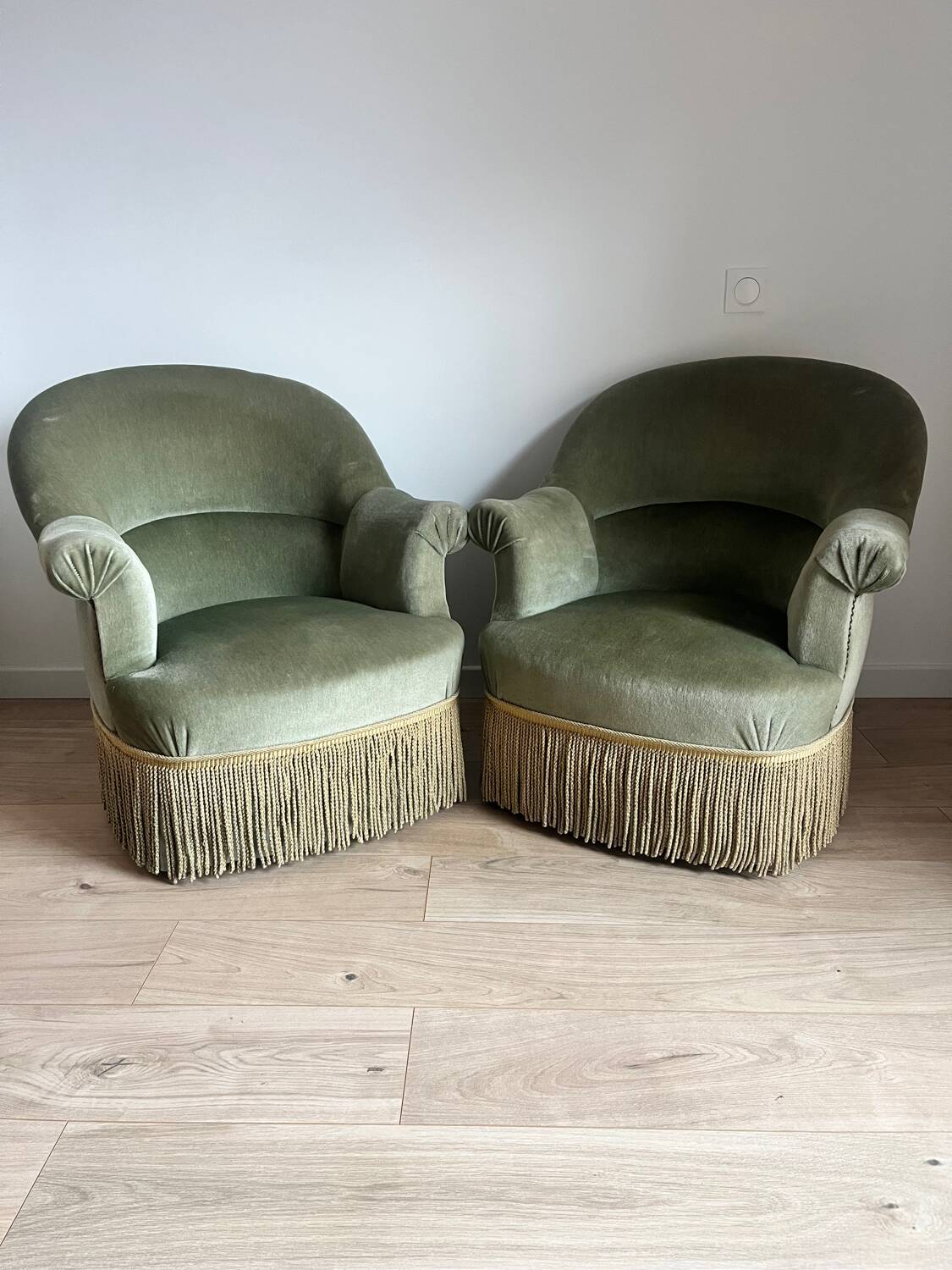 sage green toad armchairs with gold fringe