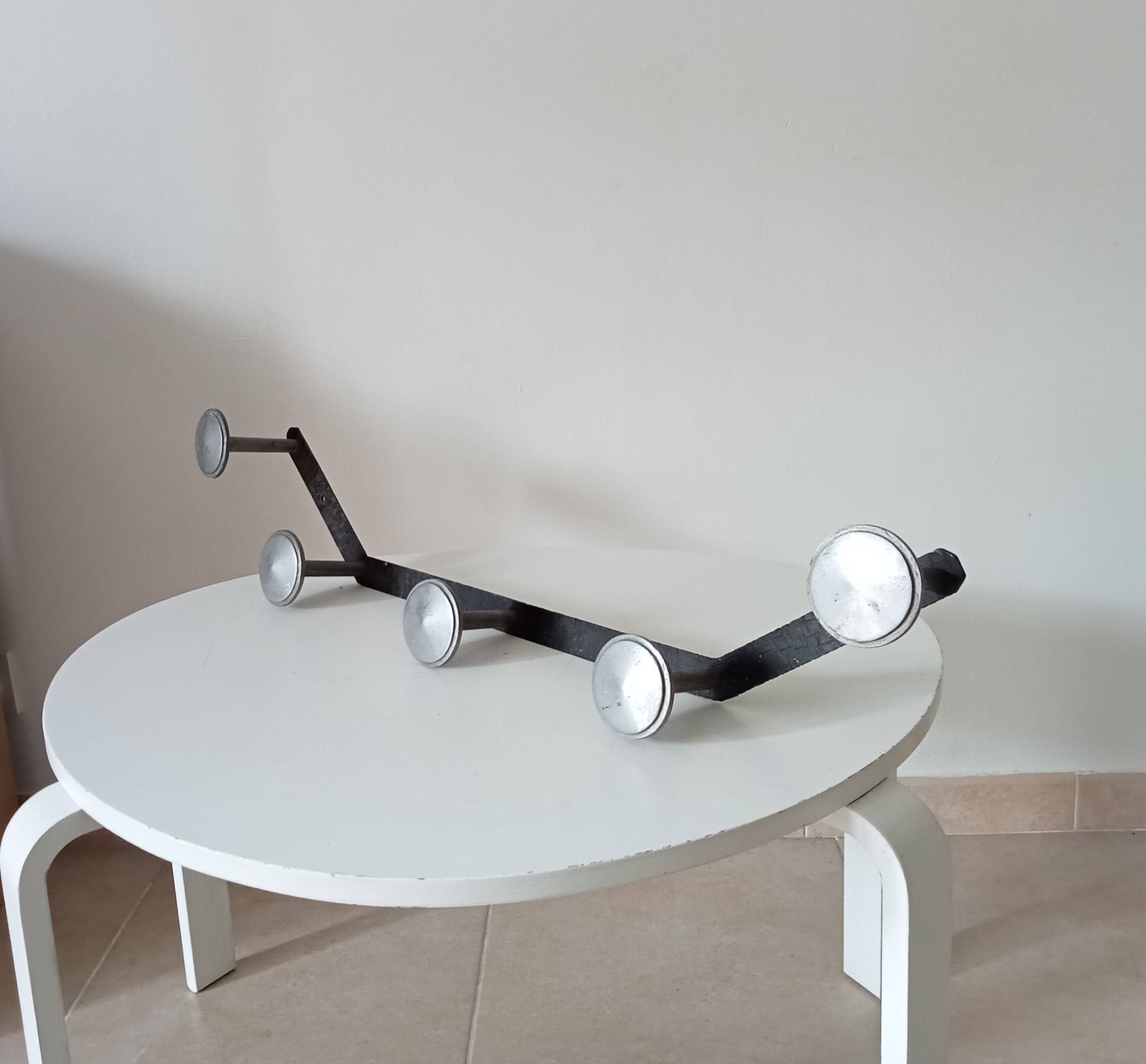 Vintage 1950s wall coat rack, wrought iron with chiselled details and solid aluminium.