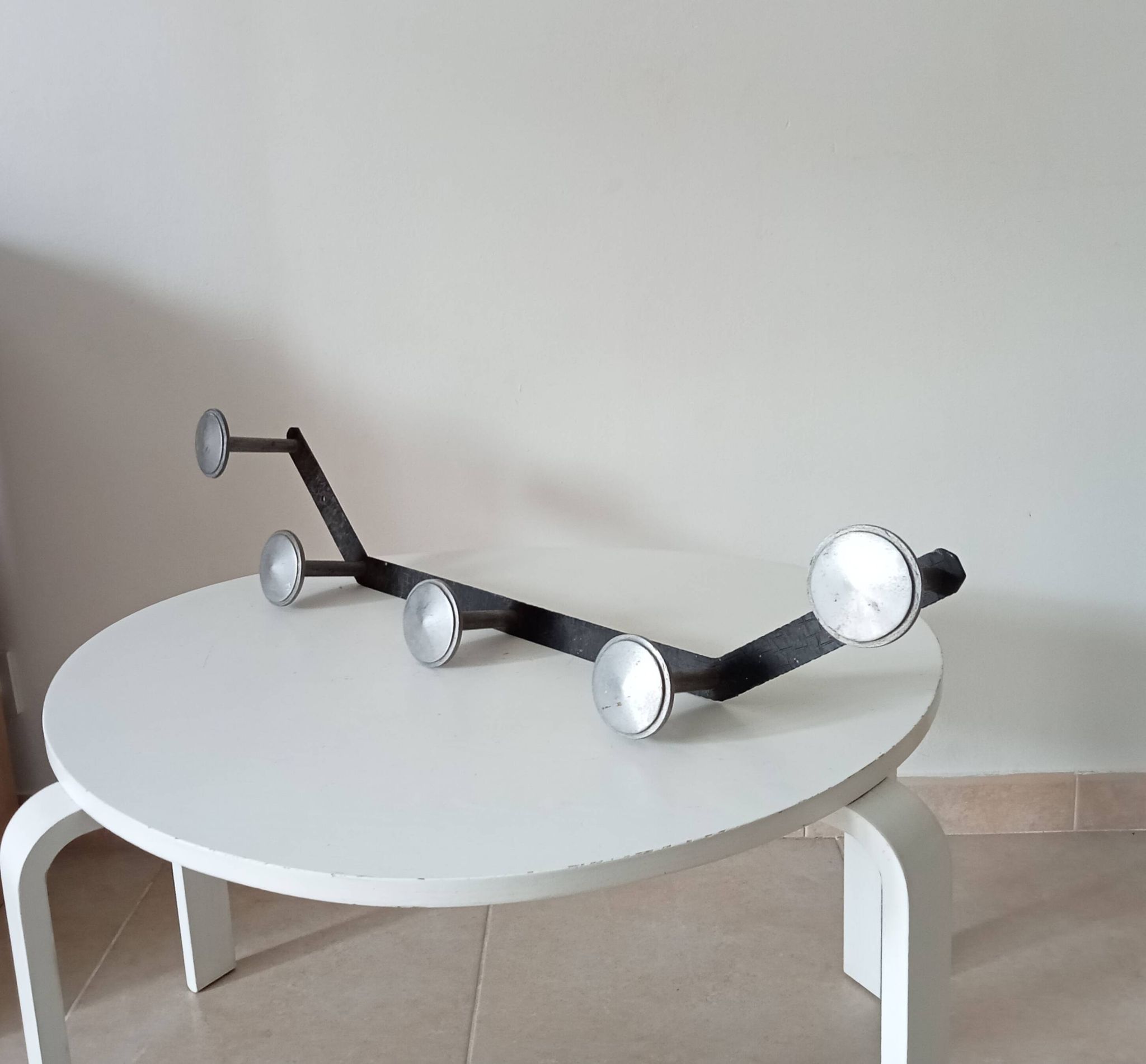 Vintage 1950s wall coat rack, wrought iron with chiselled details and solid aluminium.