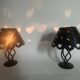 Pair of black wrought iron lanterns with heart patterns, romantic style.