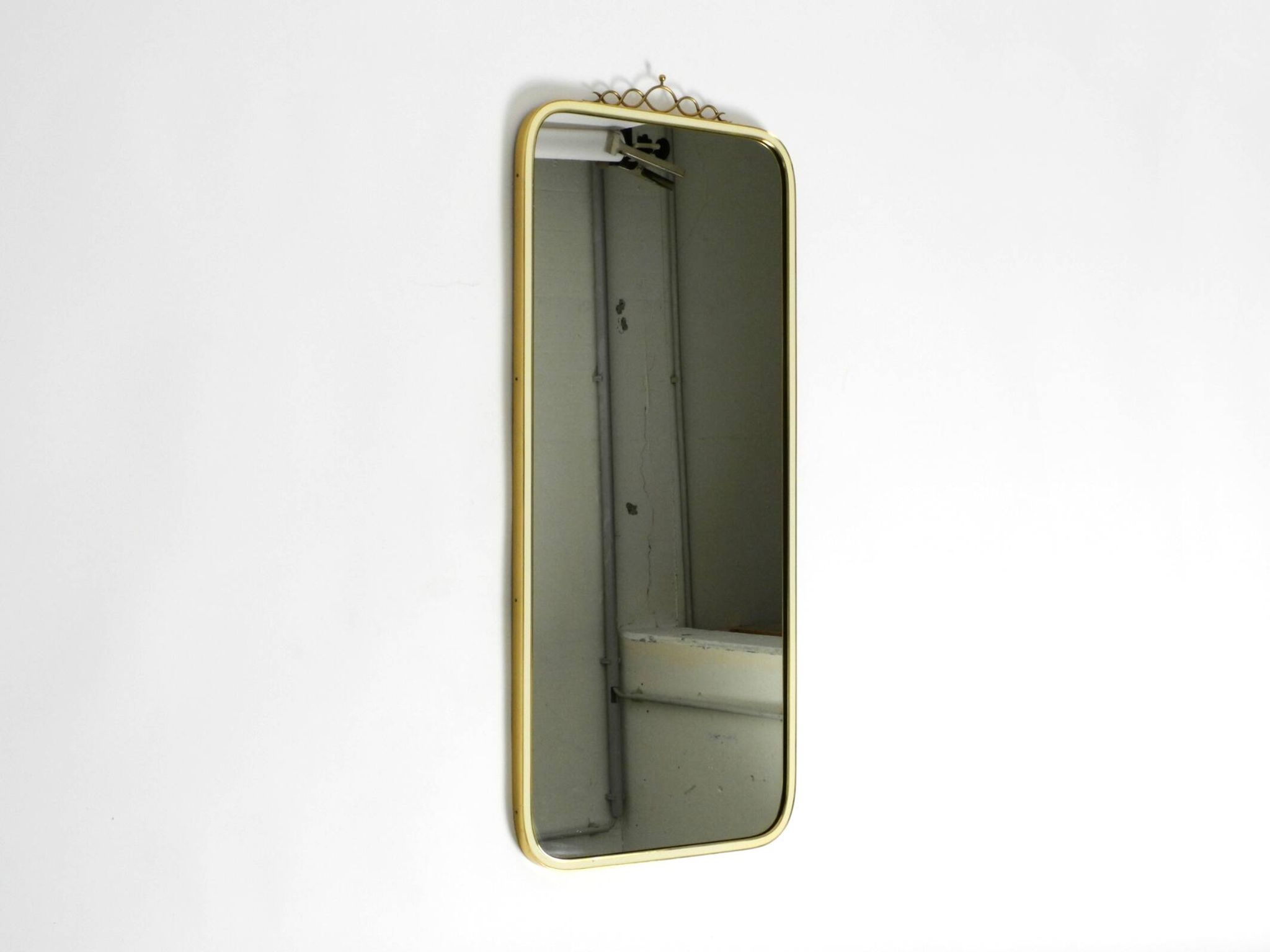 Large heavy long Mid Century brass wall mirror by Münchner Zierspiegel