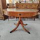 Round Regency dining table in mahogany and green leather with extensions - 20th century