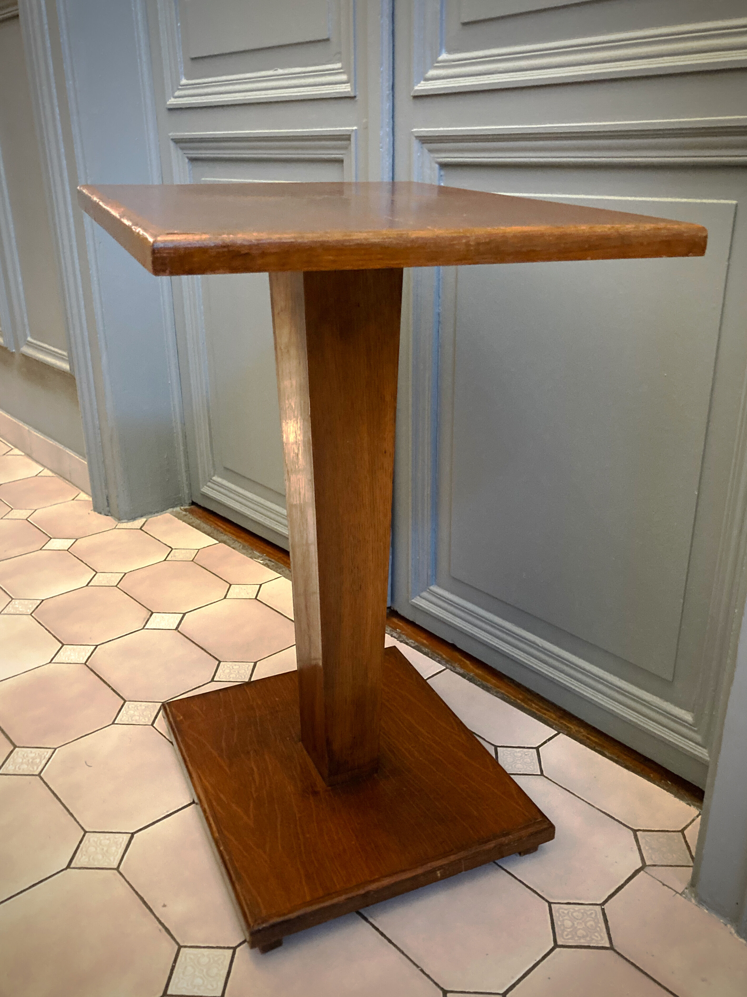 Square pedestal table with central foot 1930