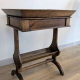 Old wooden pocket emptying table with drawer and planter.