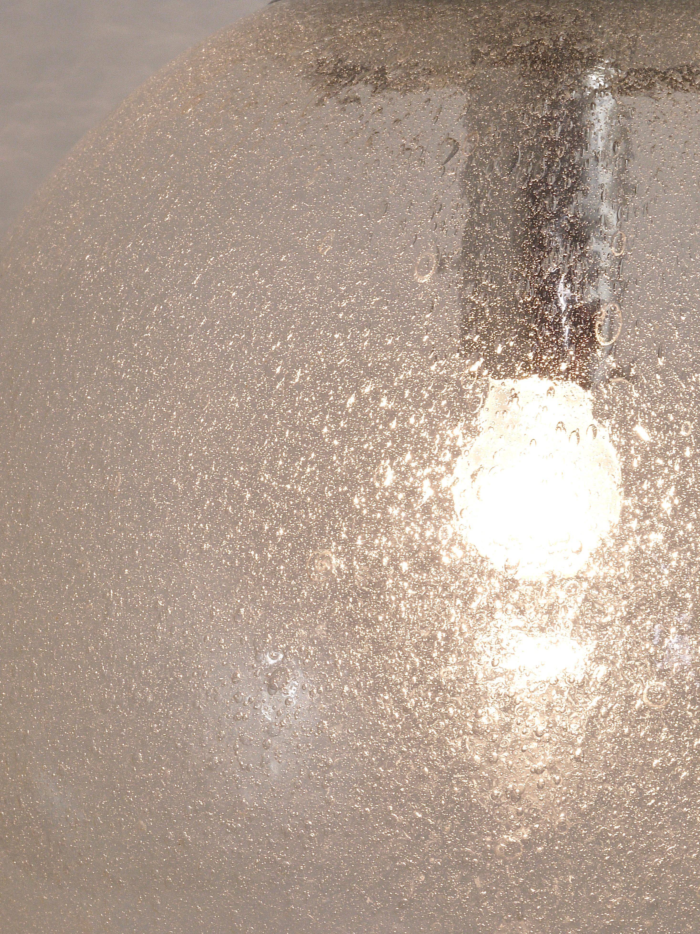 Large glass globe pendant light with bubbles and chrome by Peil & Putzler, Germany, 1970s.