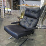 Grained leather armchair with rocking movement