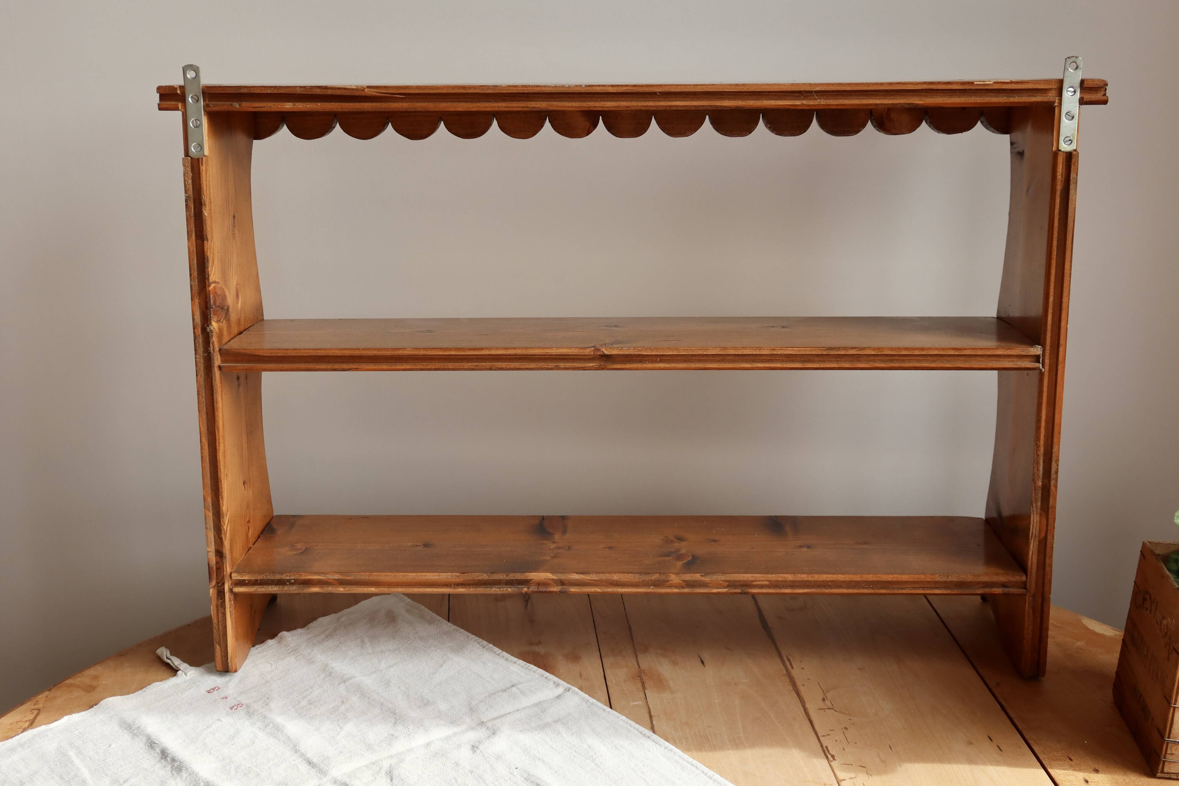 Vintage pine wall shelf with a scalloped front.
