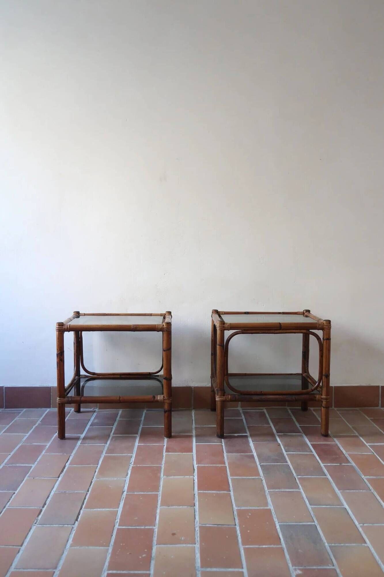 Pair of bamboo and rattan bedside tables, smoked glass tops.