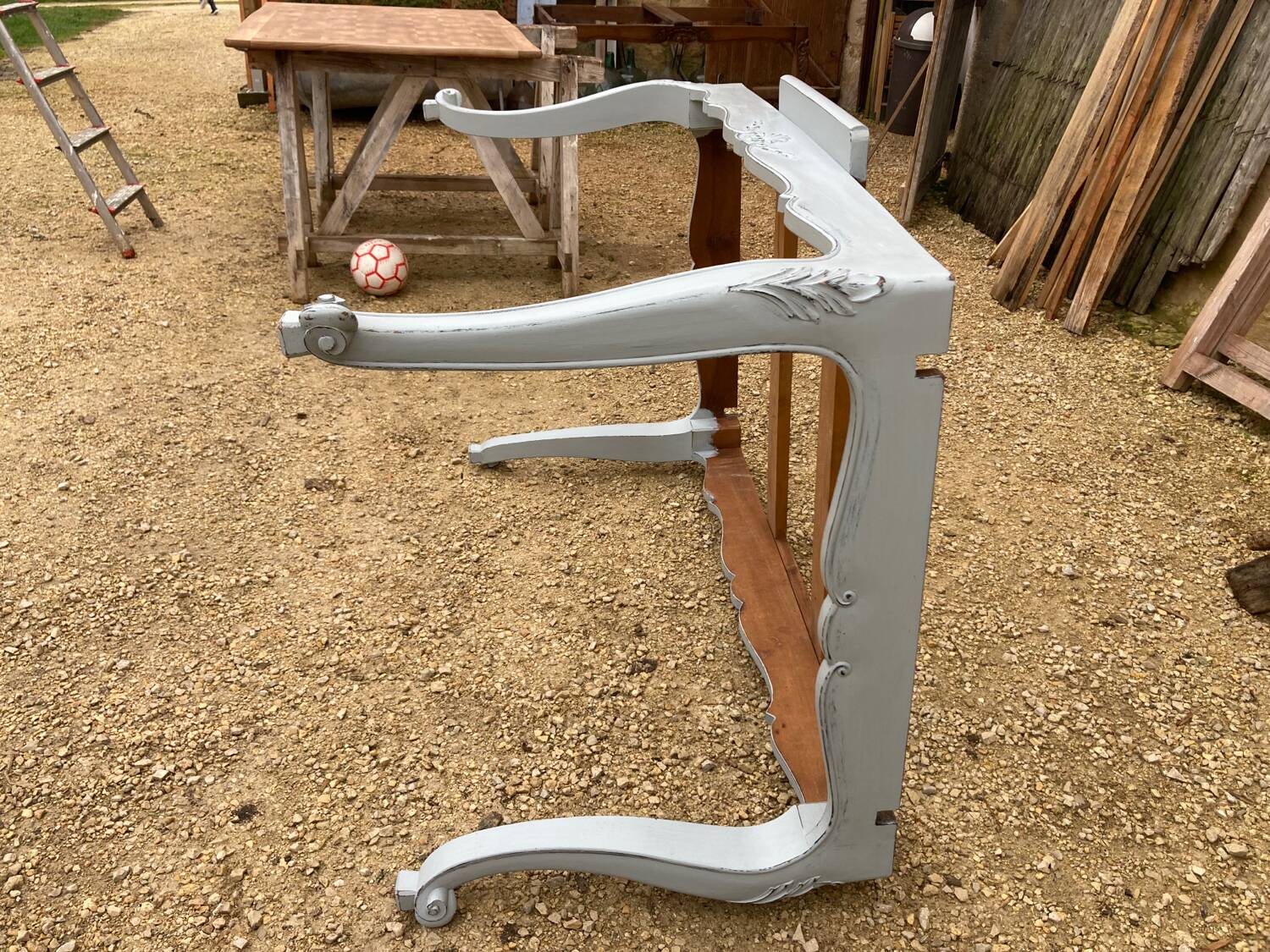 Louis XV style walnut table with a natural wood top.