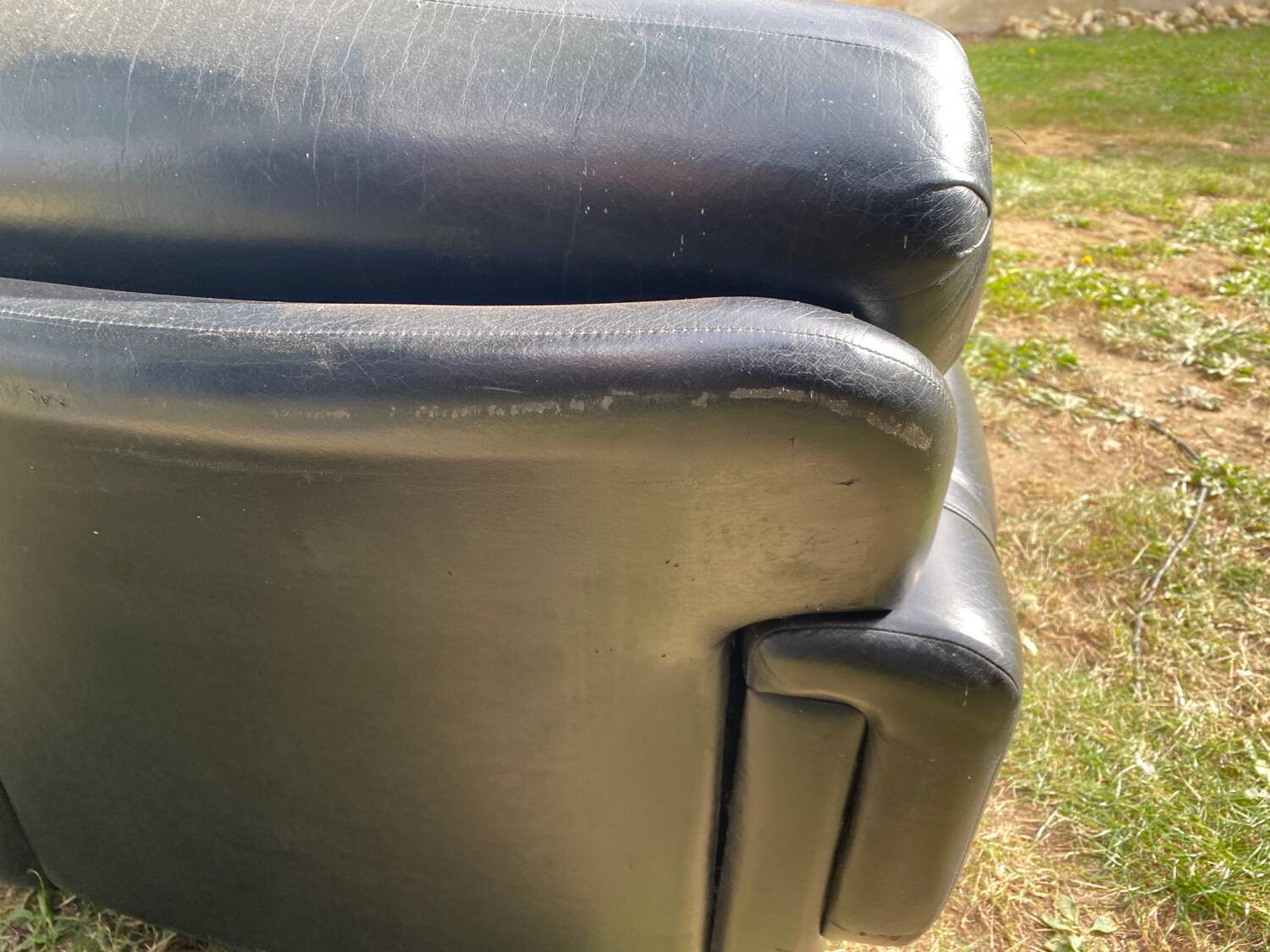 Pair of black imitation leather armchairs