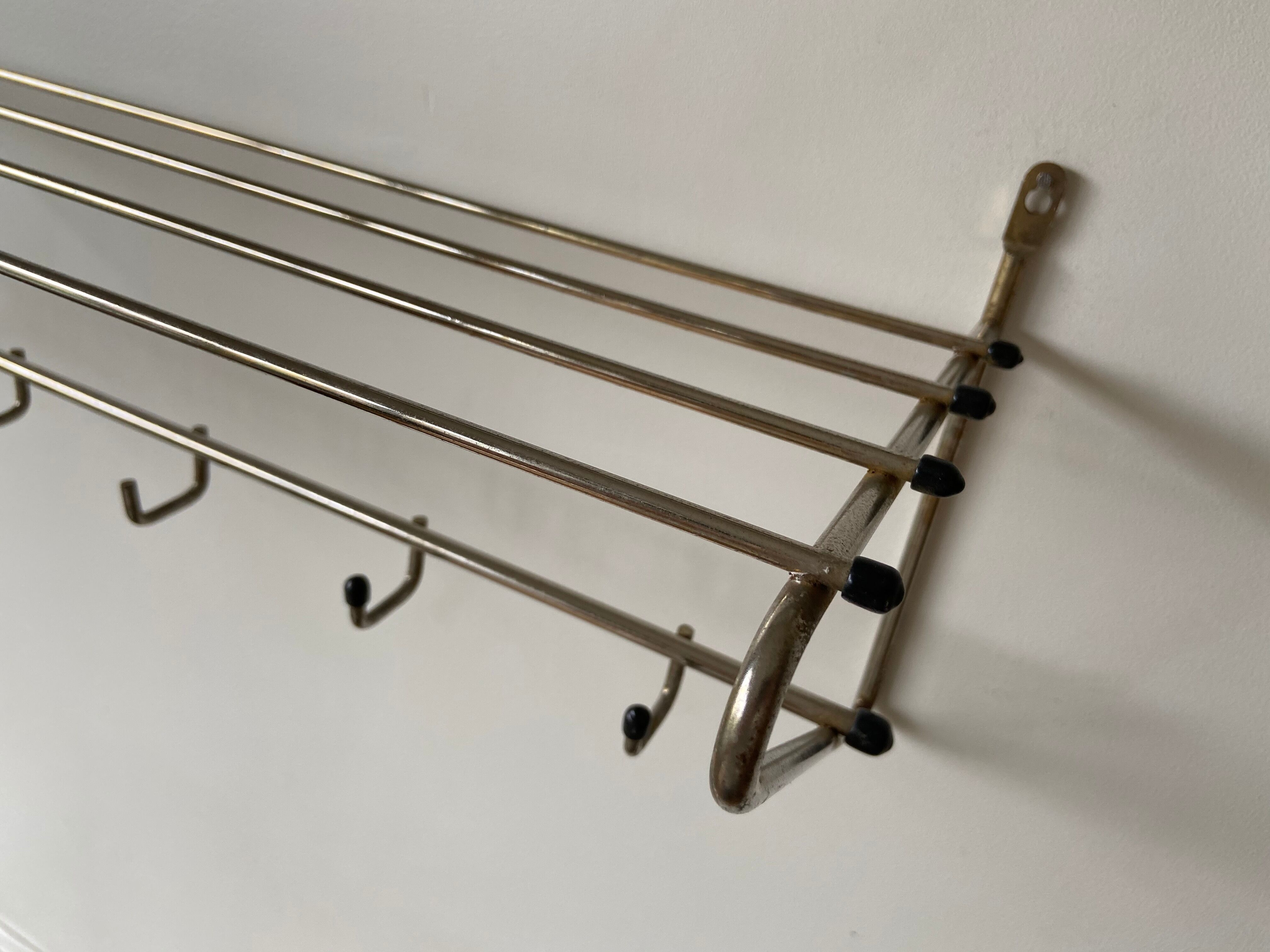 Metal wall coat holder with tablet