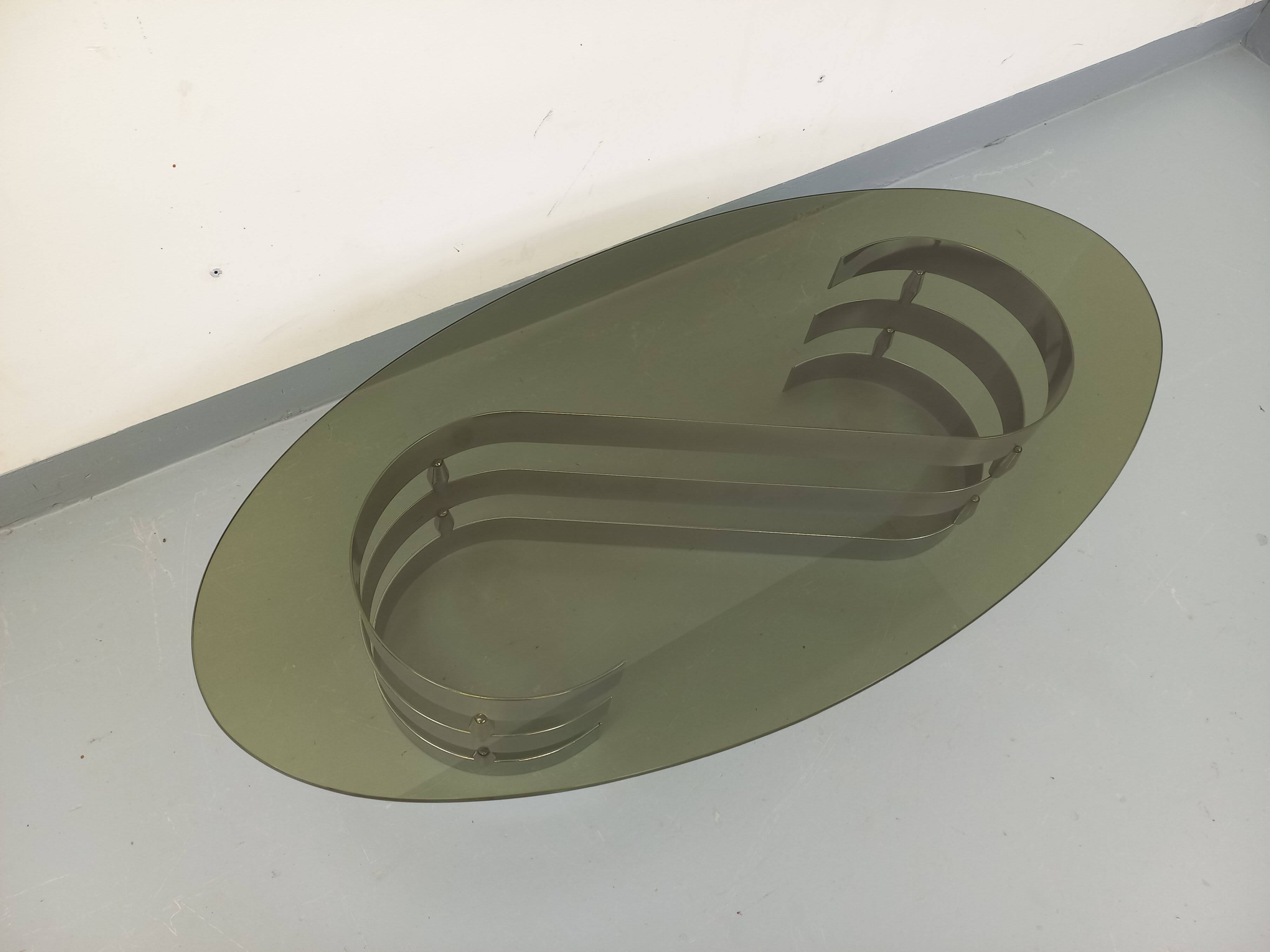 Vintage oval coffee table in smoked glass and chrome metal from the 1970s.
