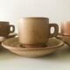 Stoneware coffee cups with saucers