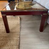 Wood and brass coffee table with a world map under glass.
