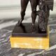 Dionysus on the shoulders of a satyr, bronze after the antique on a yellow Siena base.