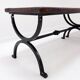 Set of 2 solid wood benches with an openwork design and wrought iron legs.