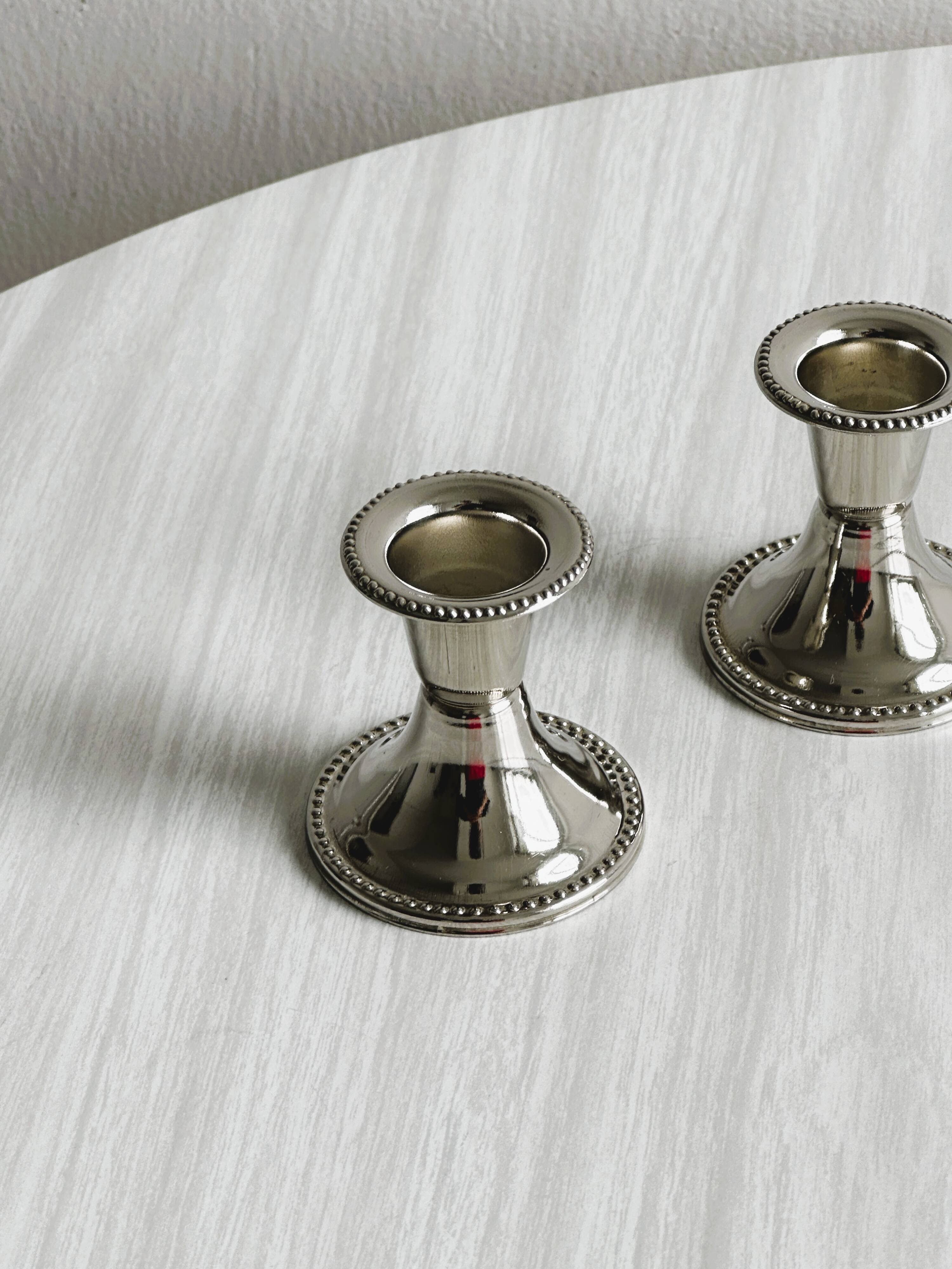 Pair of small light metal candlesticks