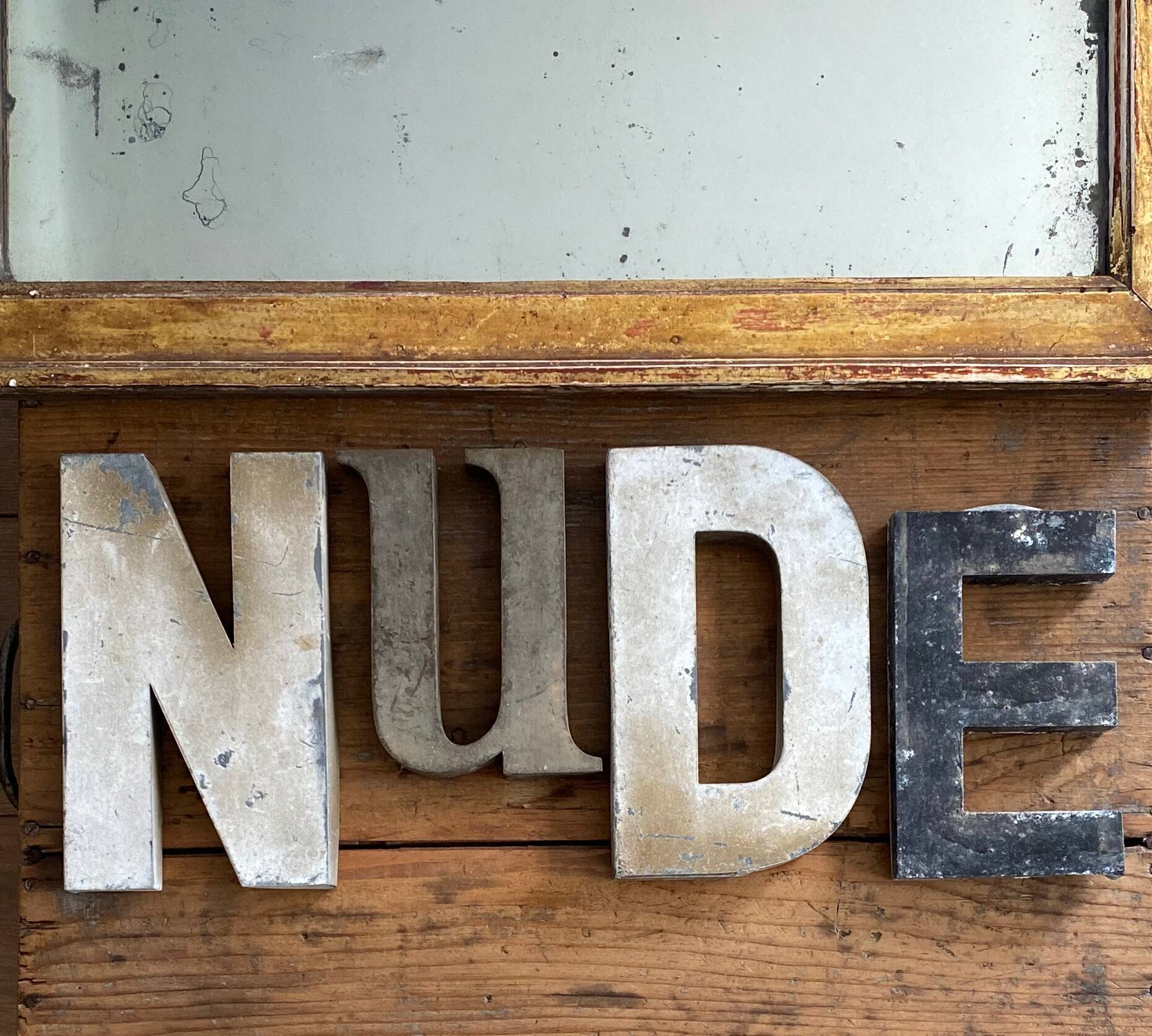 Nude sign letters