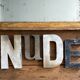 Nude sign letters