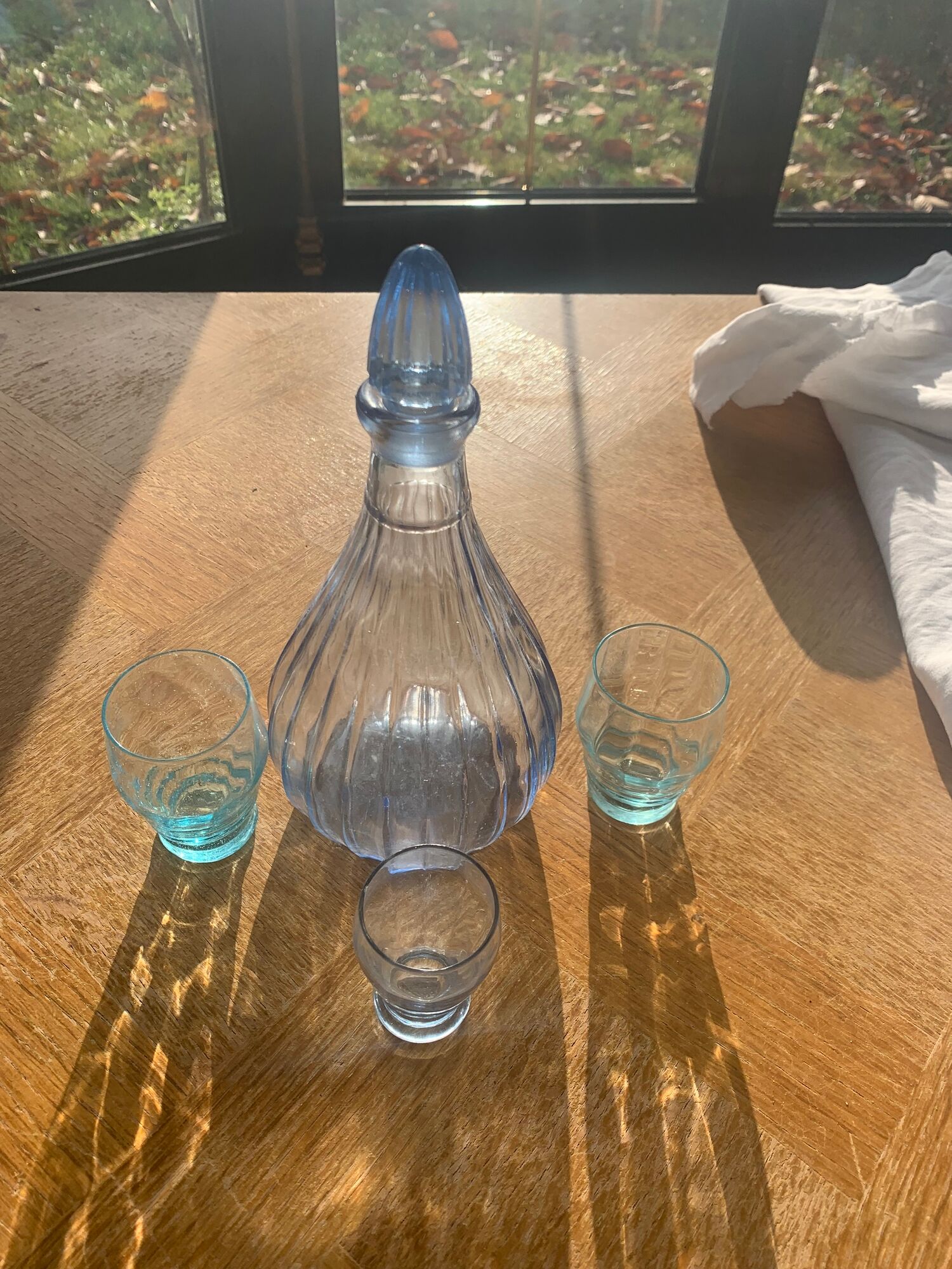 Liquor service consisting of a blue glass decanter and. 3 small antique glasses