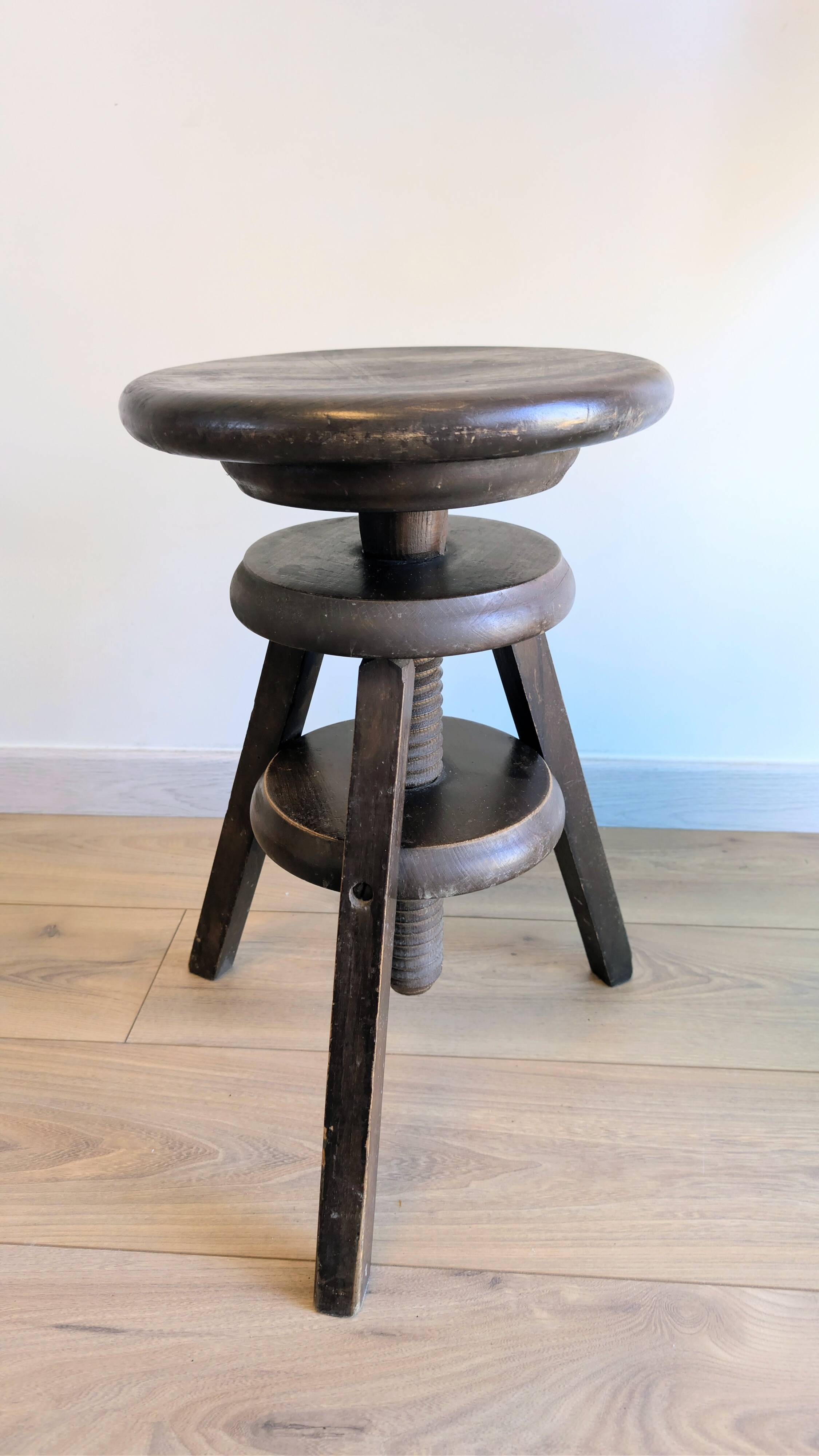 Antique wooden watchmaker's stool with screws, patinated wood.