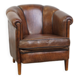Fauteuil club en cuir de mouton foncé avec passepoil noir