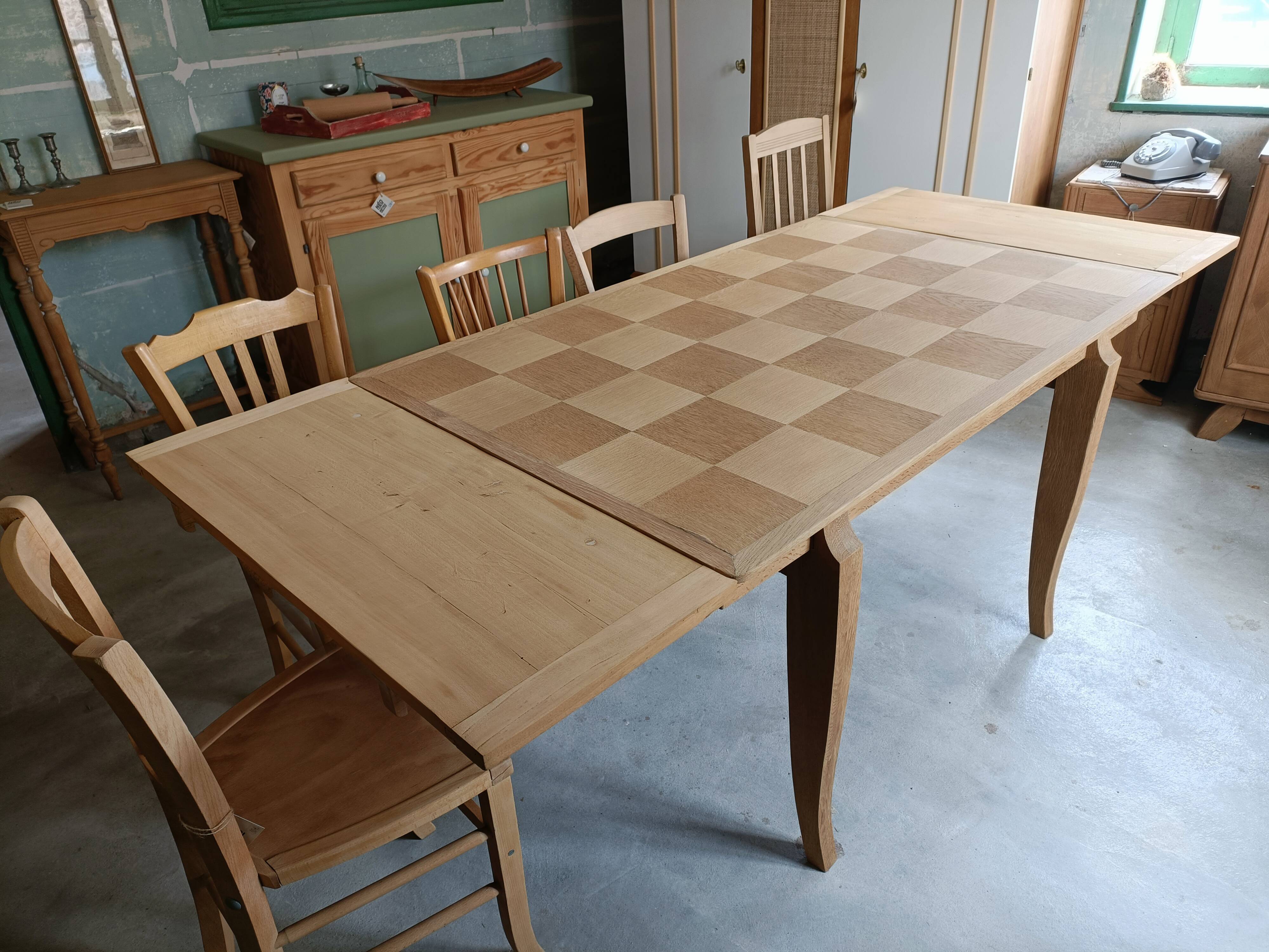 Oak dining table with a checkerboard top and extensions.