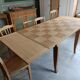 Oak dining table with a checkerboard top and extensions.