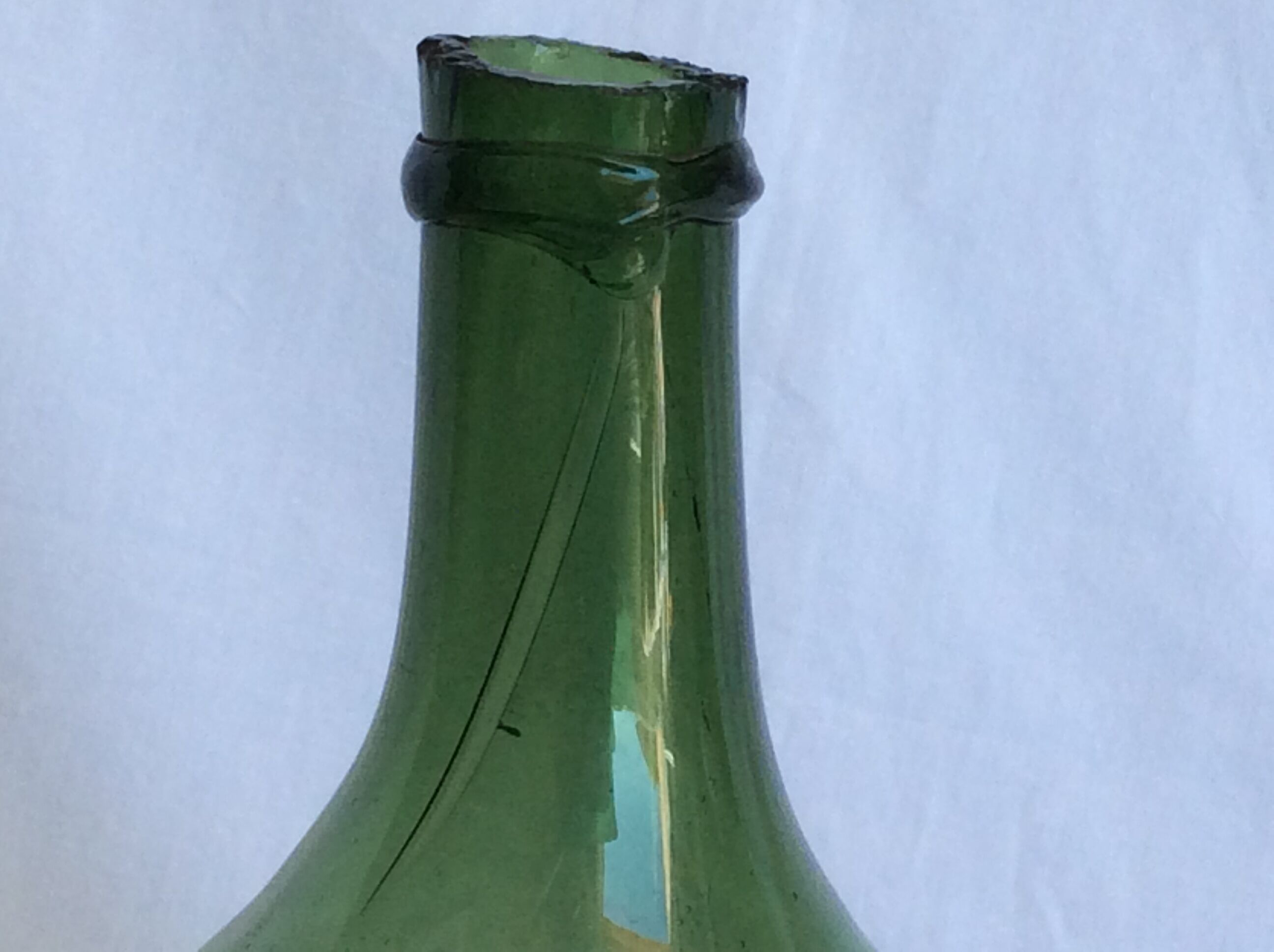 Former "lady jeanne" in blown glass, green bottle