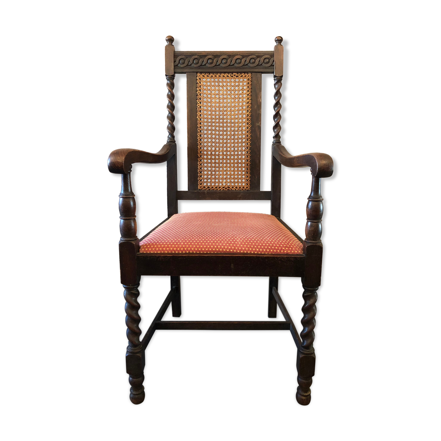 Carved wooden armchair and cannage