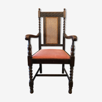 Carved wooden armchair and cannage