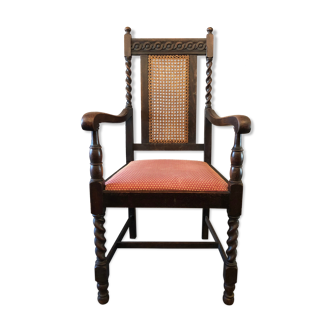 Carved wooden armchair and cannage