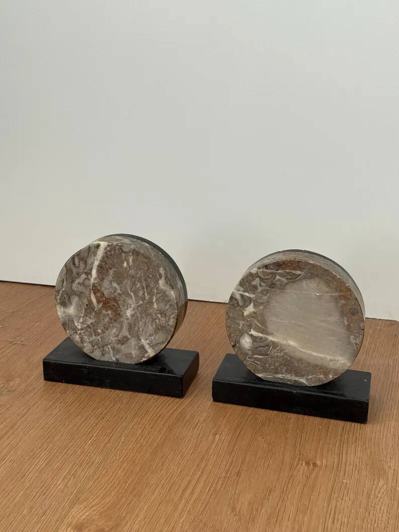 Vintage pair of bookends in fossilised coral agate | Stone disc-shaped bookends on a black marble base