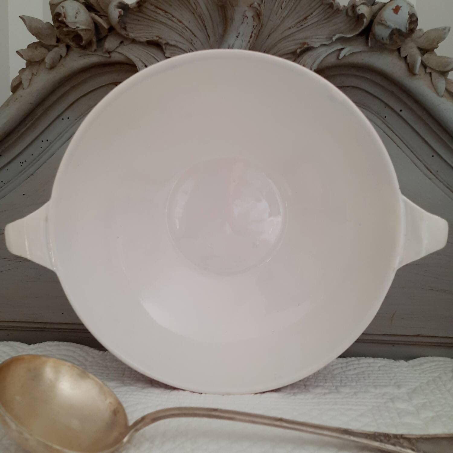 Mismatched old soup plates accompanied by a soup tureen